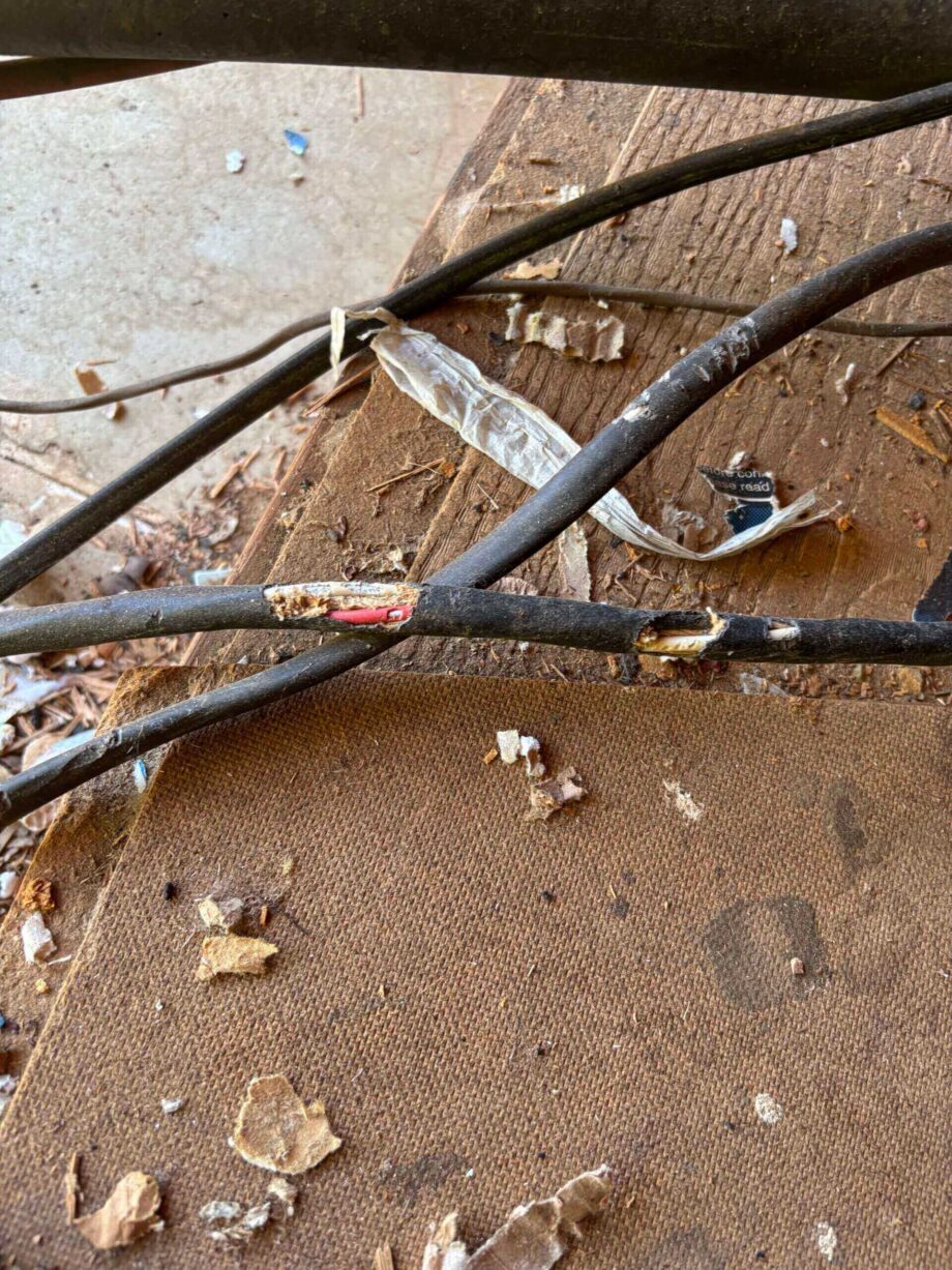Damaged cables on a wooden surface.
