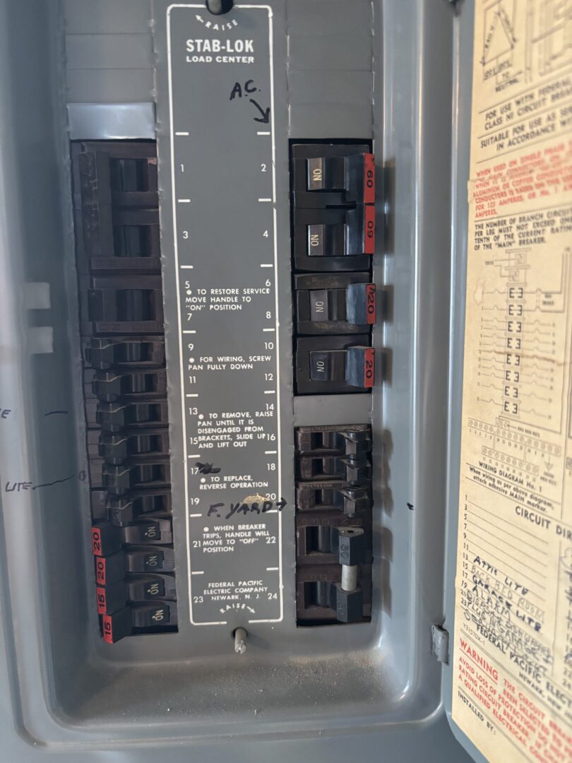 Electrical panel with circuit breakers and labels.