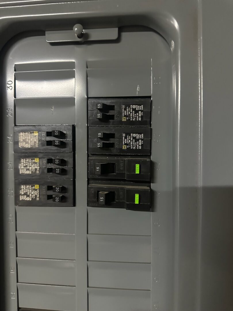 Licensed Fort Worth electrician inspecting residential circuit breaker panel showing labeled breakers