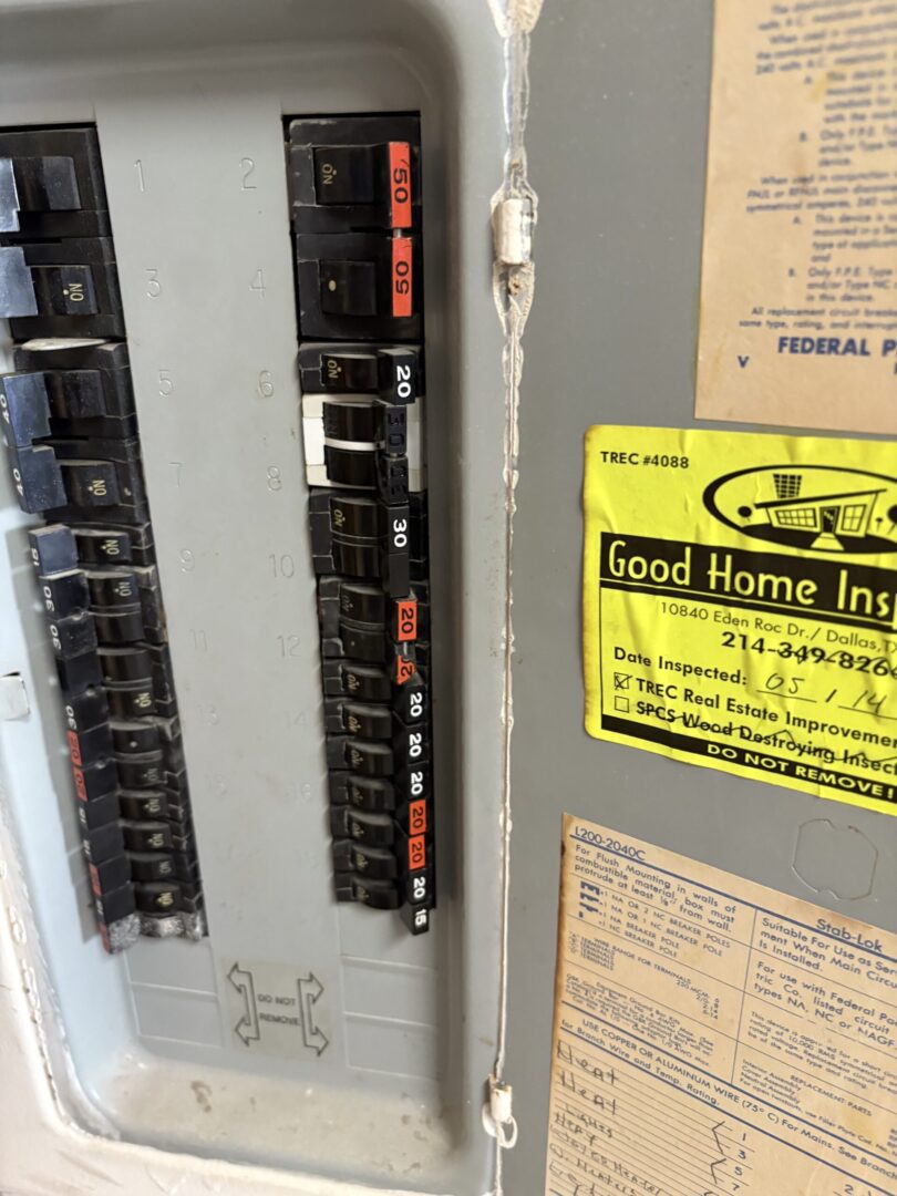 Electrical panel with circuit breakers and labels.